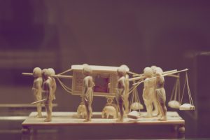 A,Miniature,Sculptural,Composition,Carved,From,Bone.,Servants,Carry,Their