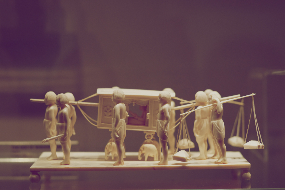 A,Miniature,Sculptural,Composition,Carved,From,Bone.,Servants,Carry,Their